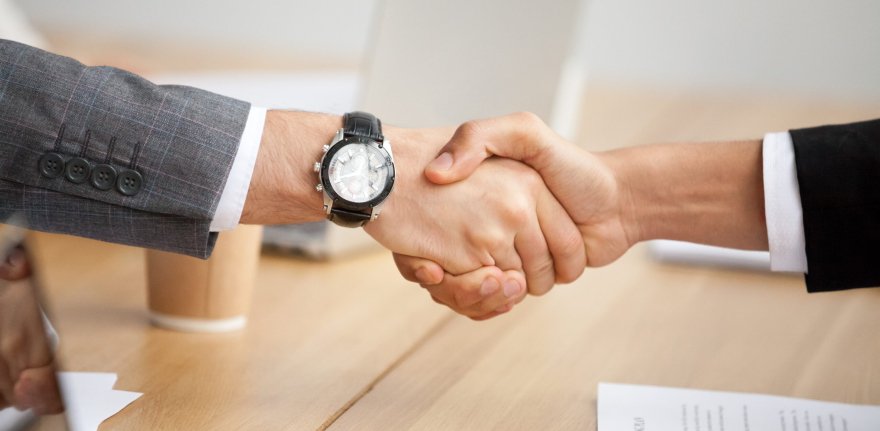 Close up view of handshake, two businessmen in suits shaking hands as concept of trust, good partnership deal, signing contract agreement at meeting, gratitude for help support in business
